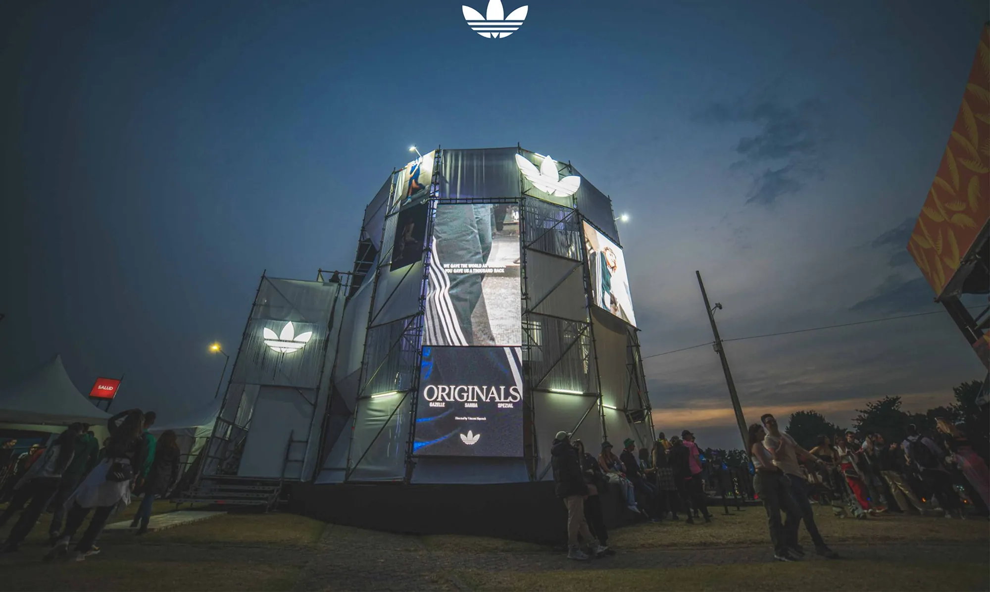 The adidas Originals Terrace Stadium at night, with festival crowds outside