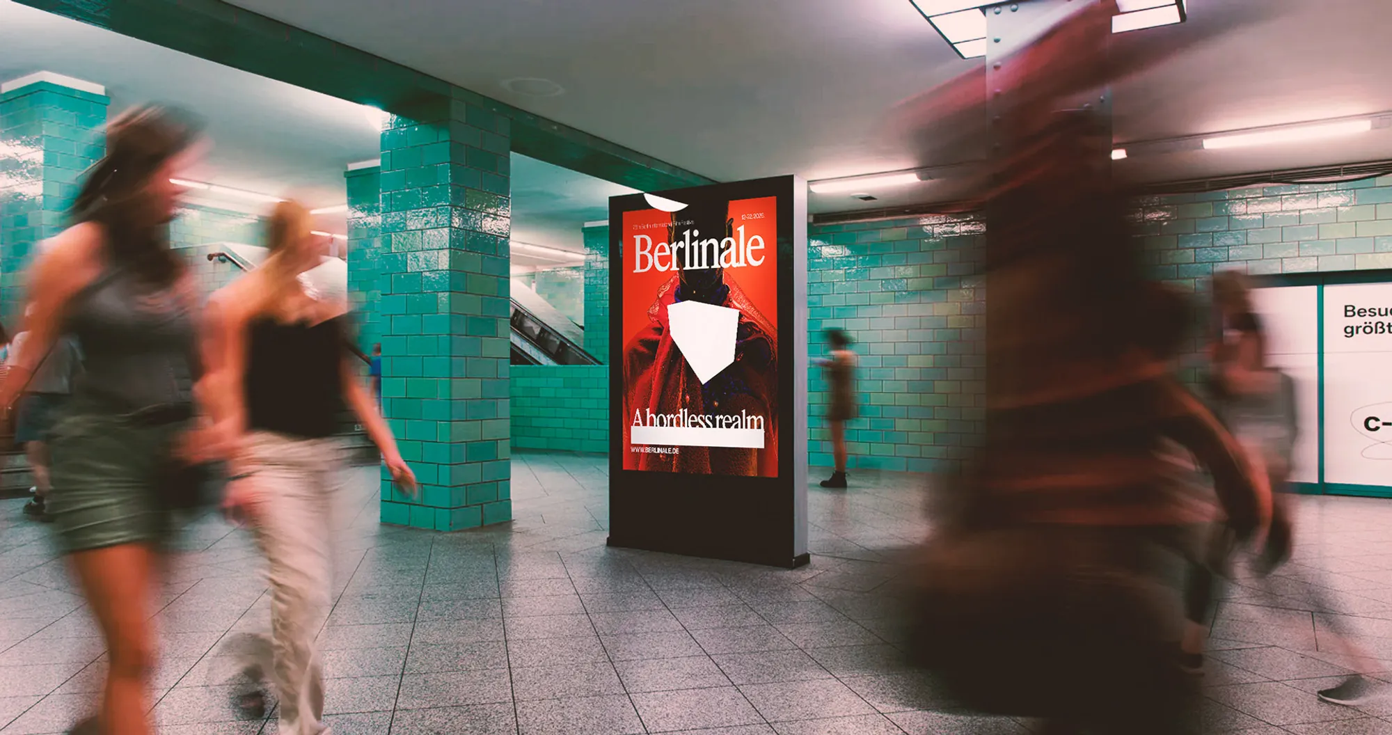 Berlinale poster in an underground station with commuters passing