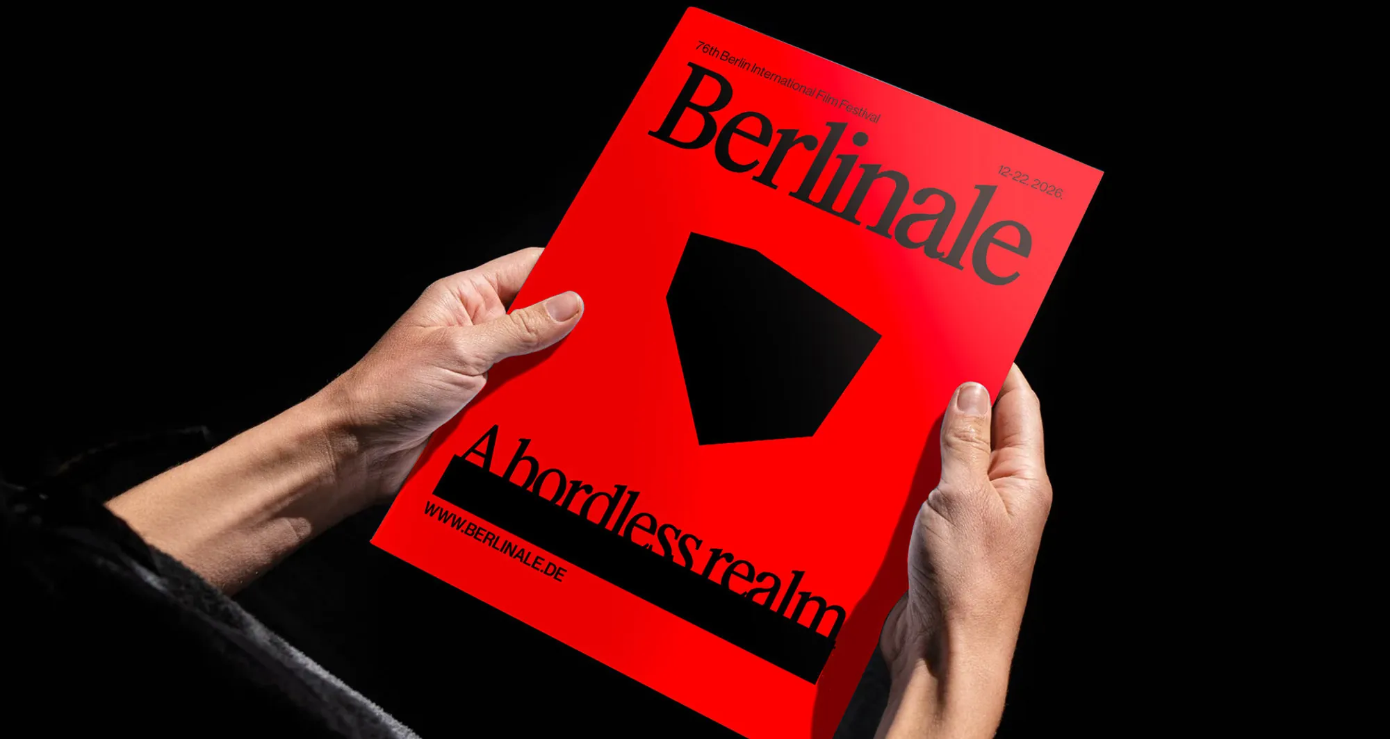 Hands holding a red Berlinale programme