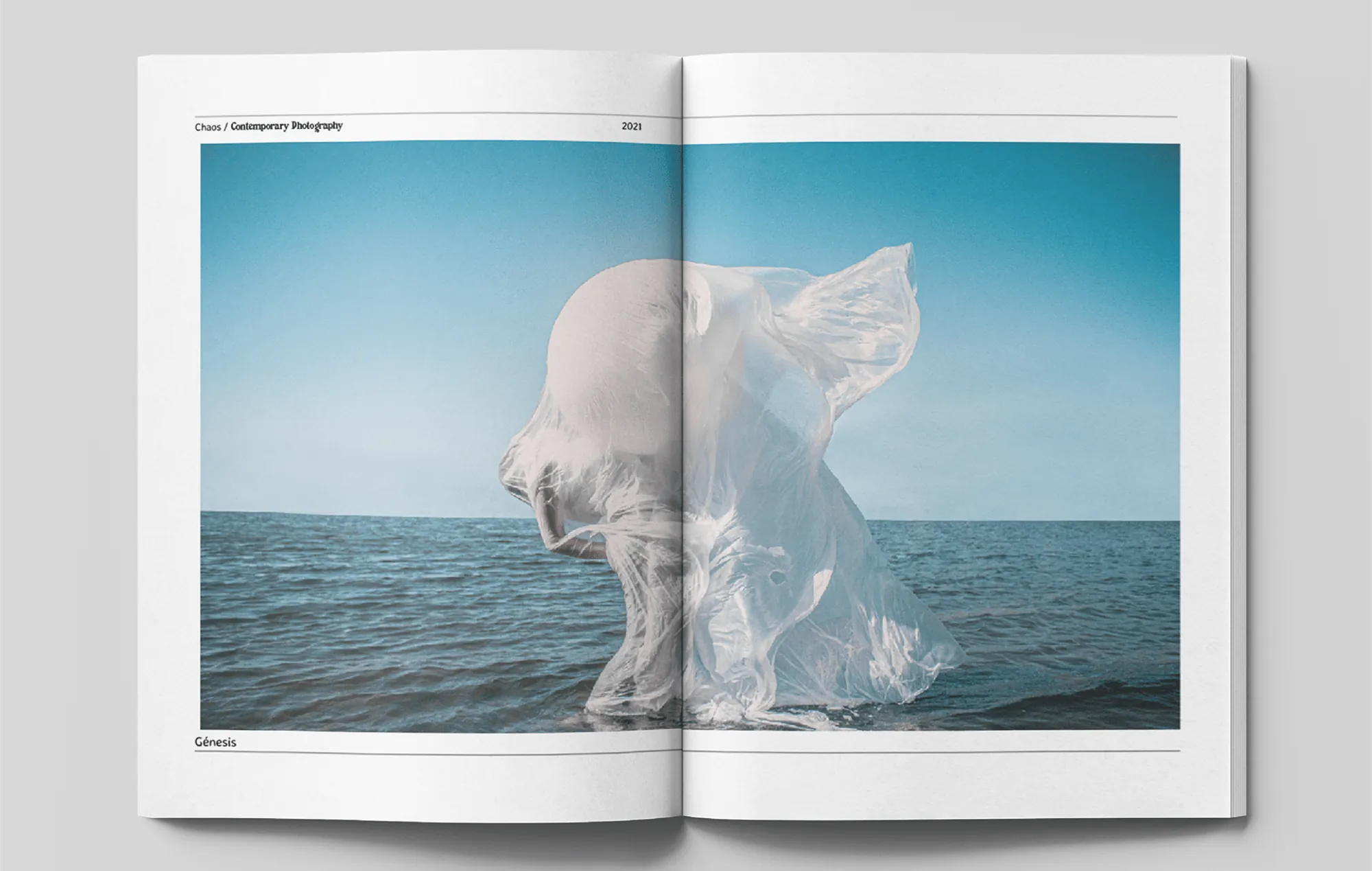 Photobook spread with a white figure against the sea