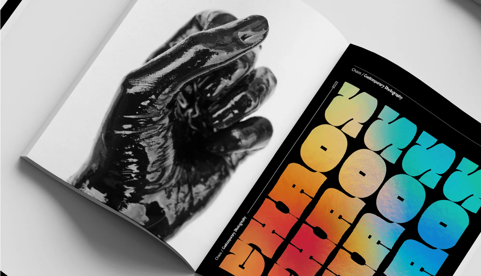 Spread with a black glove and colourful CHAOS lettering