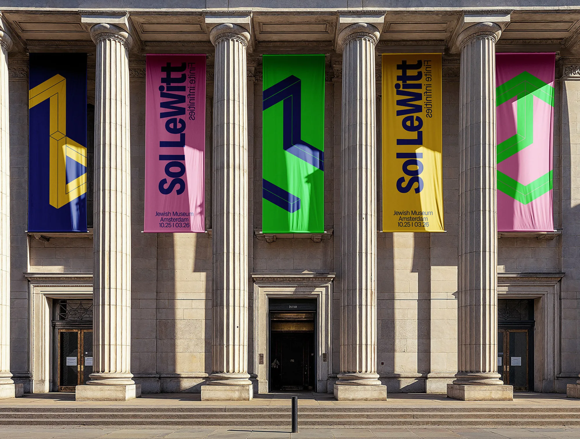 Sol LeWitt banners hanging between the columns of a museum facade