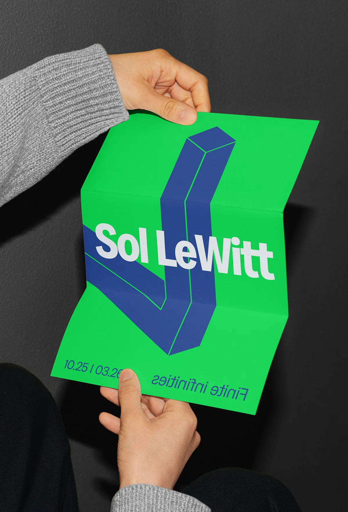 Hands holding a green Sol LeWitt poster