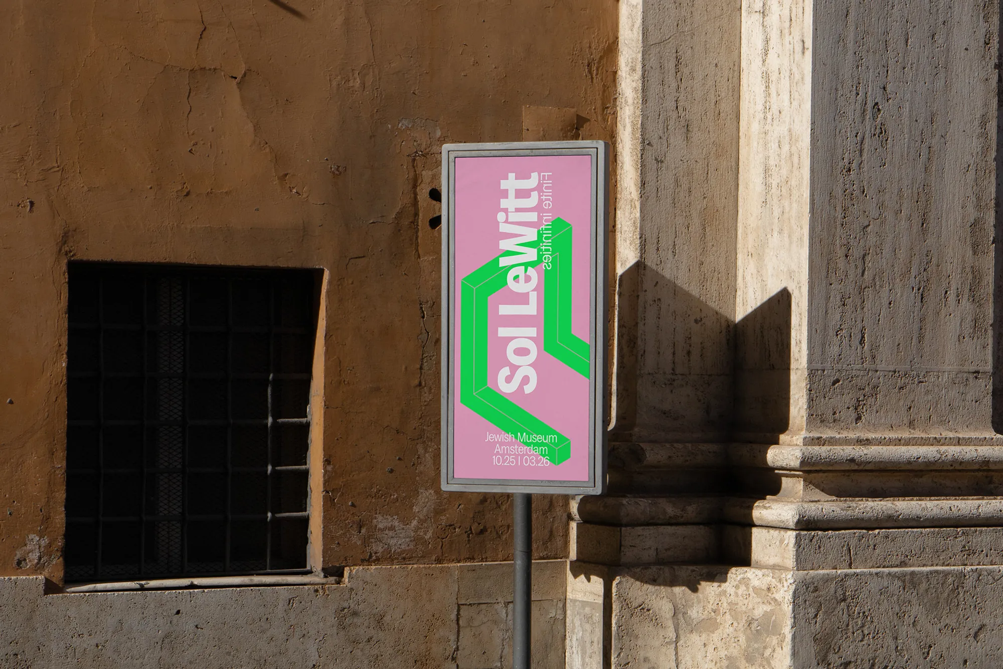 Pink street banner on an old stone building