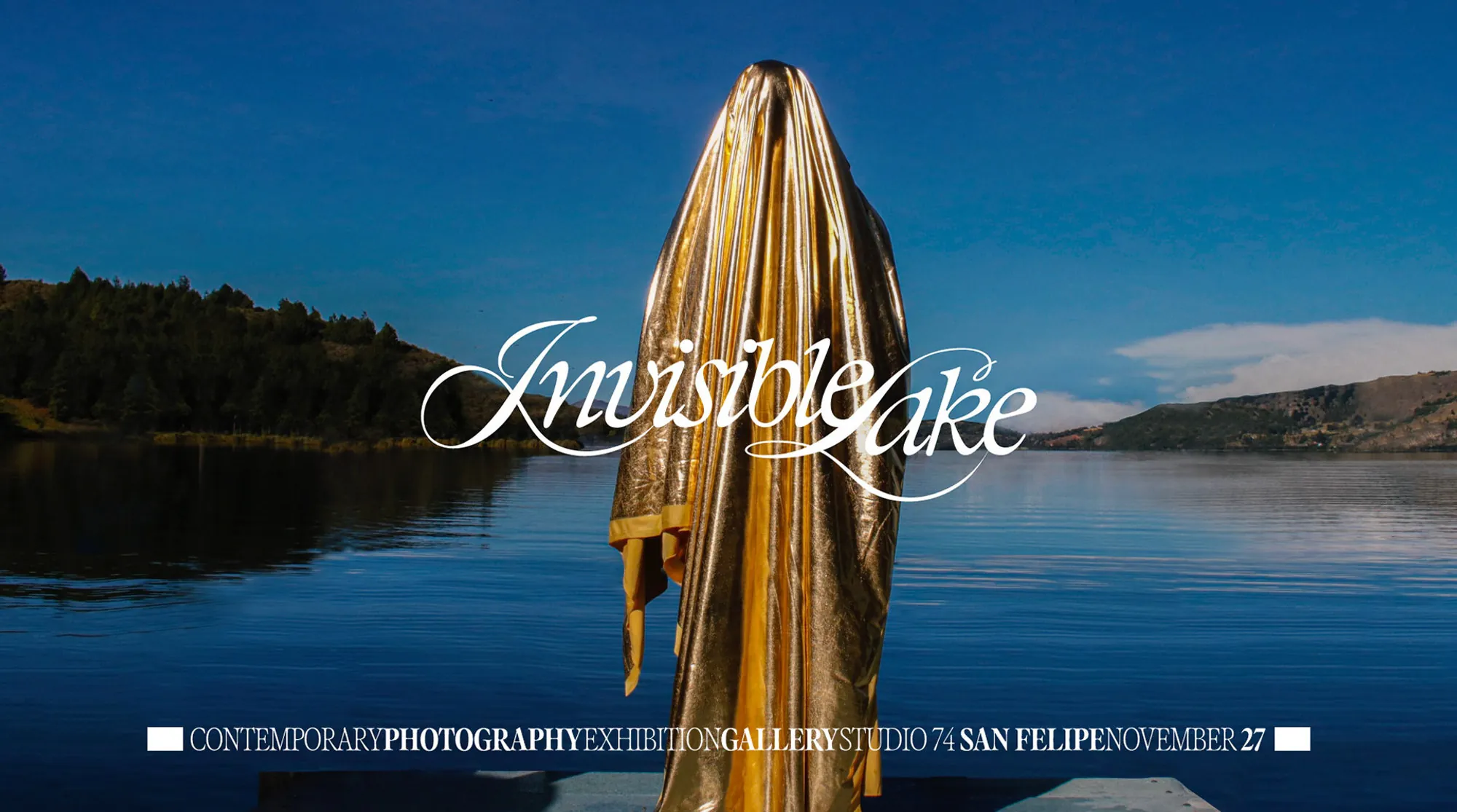 A figure draped in gold fabric standing in Lake Tota under the Invisible Lake title