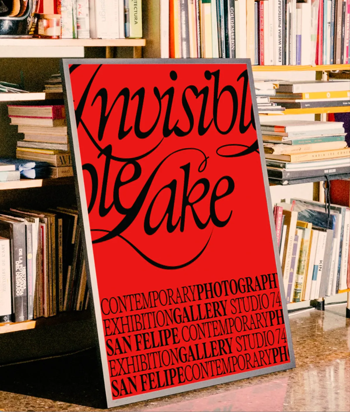 Red Invisible Lake poster propped against a bookshelf